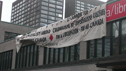 Nov 11th, 2015. Demilitarize McGill. Facing remembrance day ceremony on lower field. 